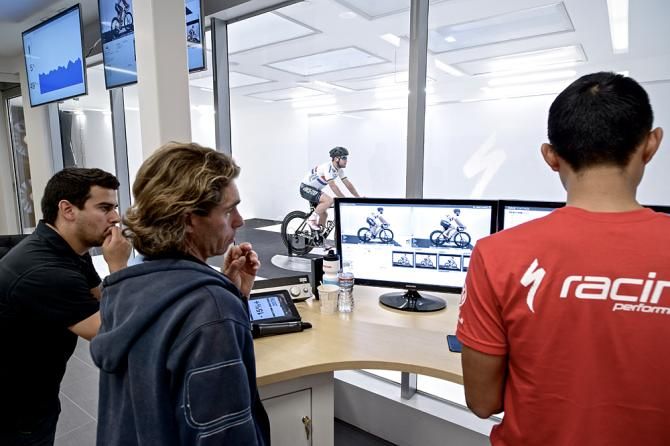 The Specialized crew watch on as Cavendish rides in the tunnel