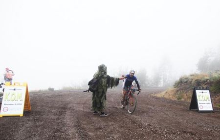 Neil Shirley collects a wad of bills for being the first man across the Competitive Cyclist K.O.M. line.