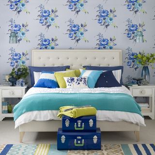 bedroom with blue floral wallpaper and bed