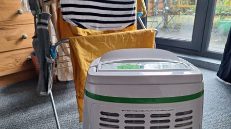 Meaco 12L Low Energy Dehumidifier in front of a rack of drying clothes