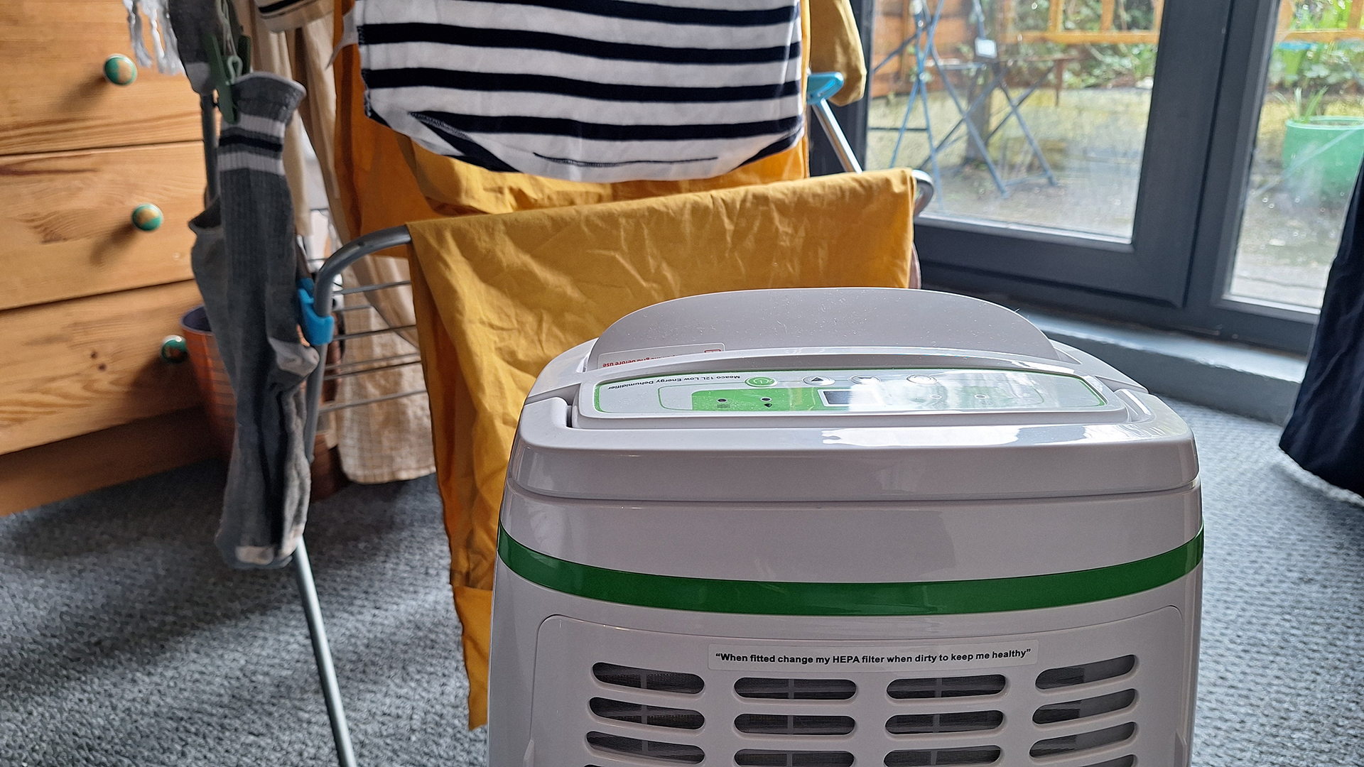 Meaco 12L Low Energy Dehumidifier in front of a rack of drying clothes