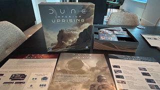 Dune: Imperium - Uprising box and contents laid out on a table
