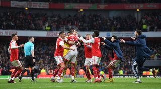 Arsenal players and staff celebrate on the pitch after Reiss Nelson scored their team's third goal during the Premier League match between Arsenal and AFC Bournemouth at the Emirates Stadium on 4 March, 2023 in London, United Kingdom.