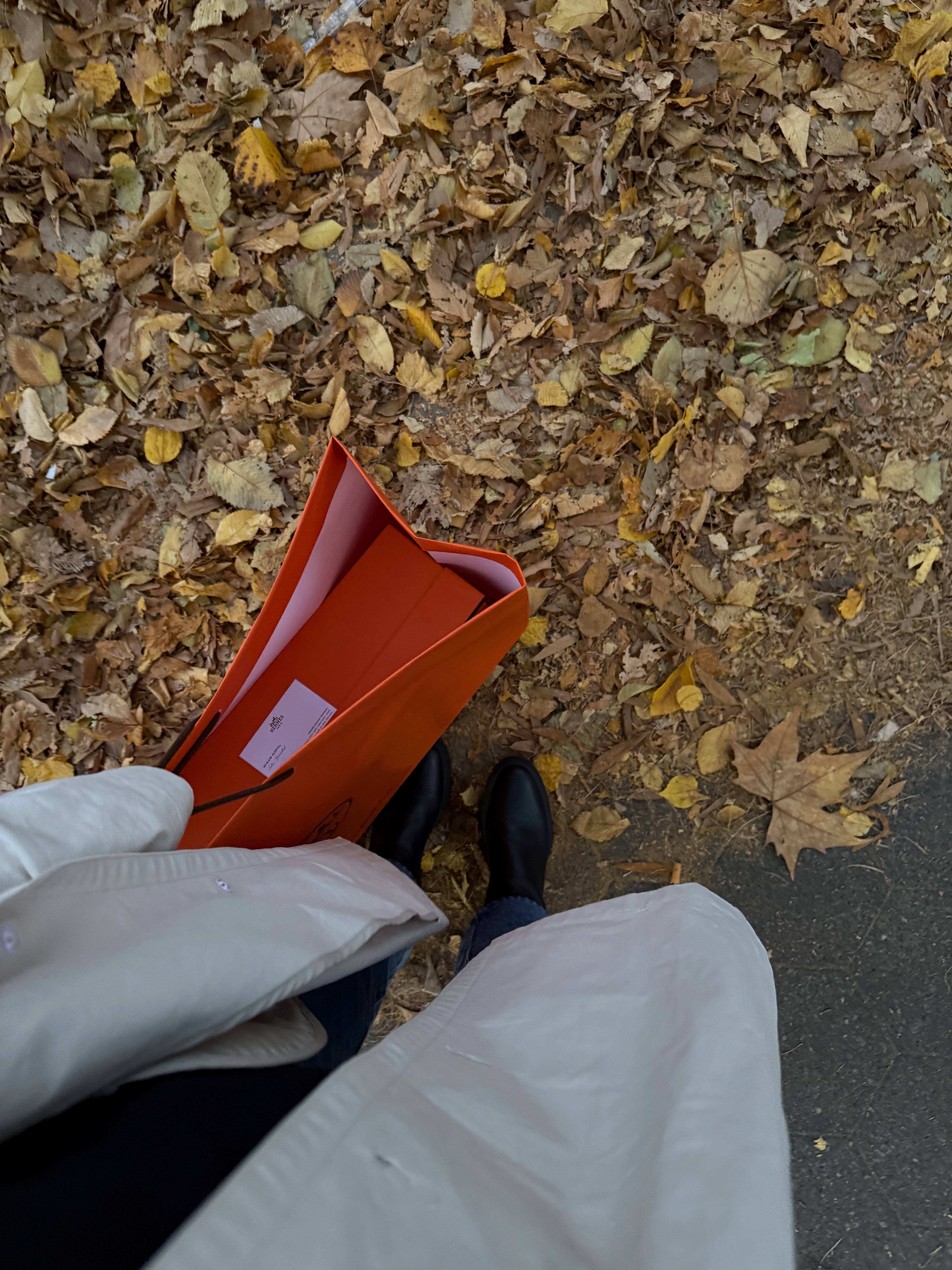 Kira Mackenzie Jackson holding her investment Hermes boots