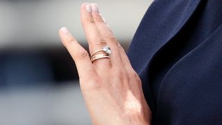 Meghan, Duchess of Sussex wearing her engagement ring as she travels down The Mall in a horse drawn carriage