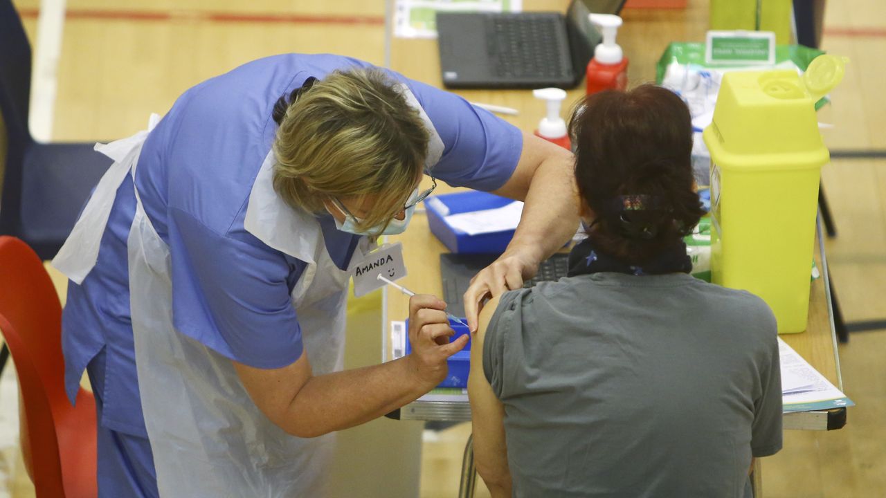 A member of the public receives a dose of the Oxford-AstraZeneca vaccine