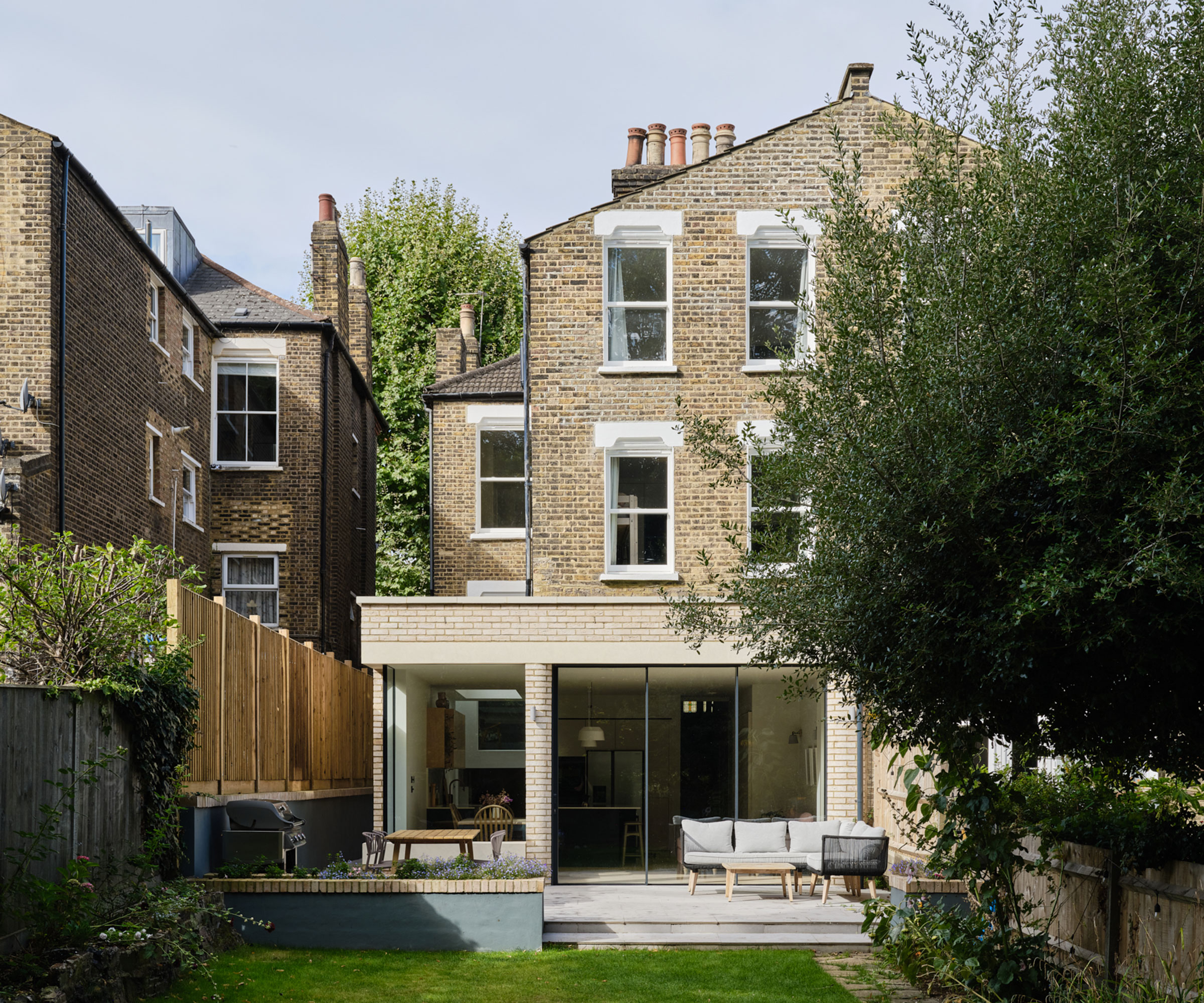 three-storey Victorian house with modern single storey extension and sliding doors