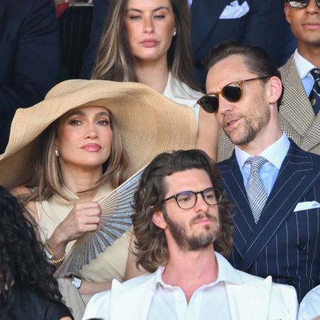 Jennifer Lopez attends Wimbledon on July 12, 2026 wearing a massive raffia hat and a dress from Ralph Lauren, joining Tom Hiddleston who wears a navy pinstripe suit