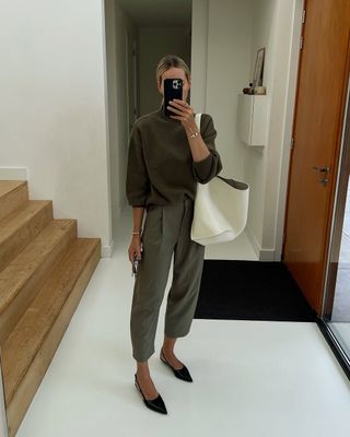 Anouk in cropped olive khaki trousers and jumper