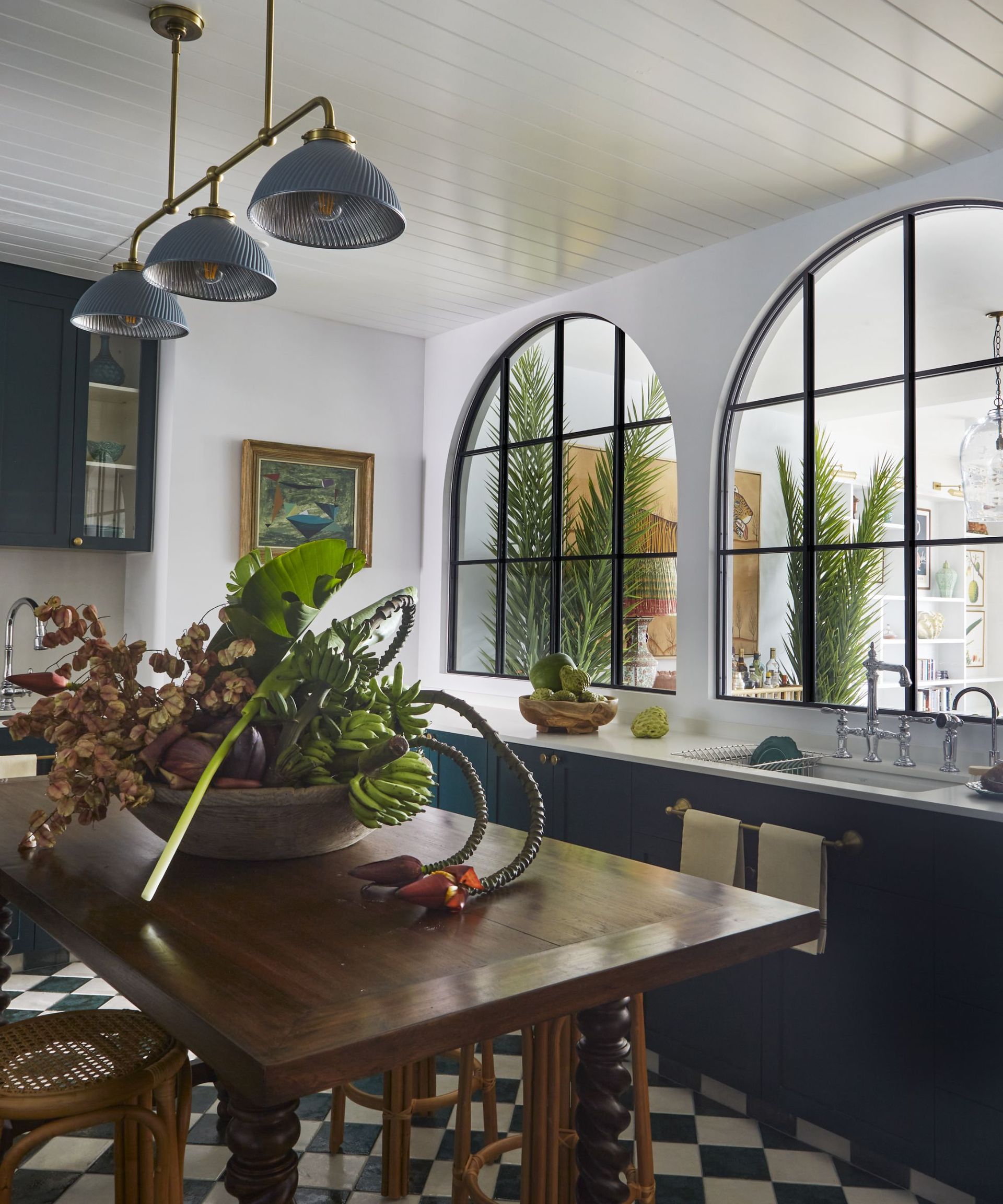 Blue cabinets, windows, blue lights, wooden chairs