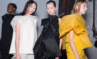 Models are in white, black and yellow colored dress.