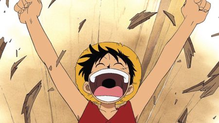 Luffy smiling and breaking apart some wooden floor boards during the anime One Piece. 