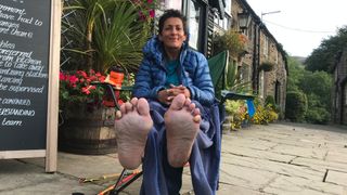 Sabrina Verjee shows off the soles of her feet after running the Pennine Way