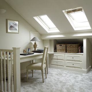 attic room with drawers under sloping wall with wooden basket