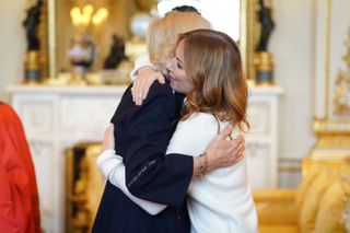 Queen Camilla hugging Geri Horner at Buckingham Palace