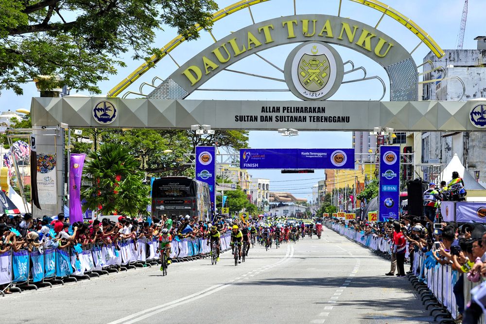 The riders head through the finish area