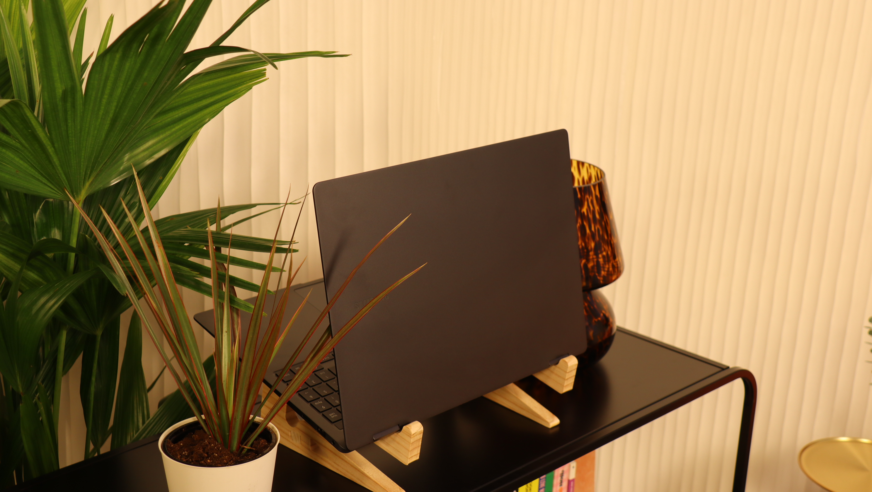 Samsung Galaxy Book3 on a wooden stand