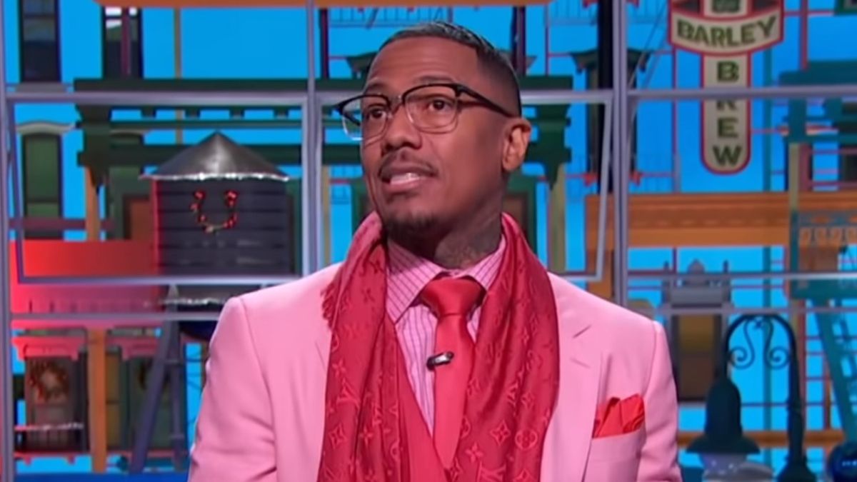 Nick Cannon wearing pink suit and tie on his talk show