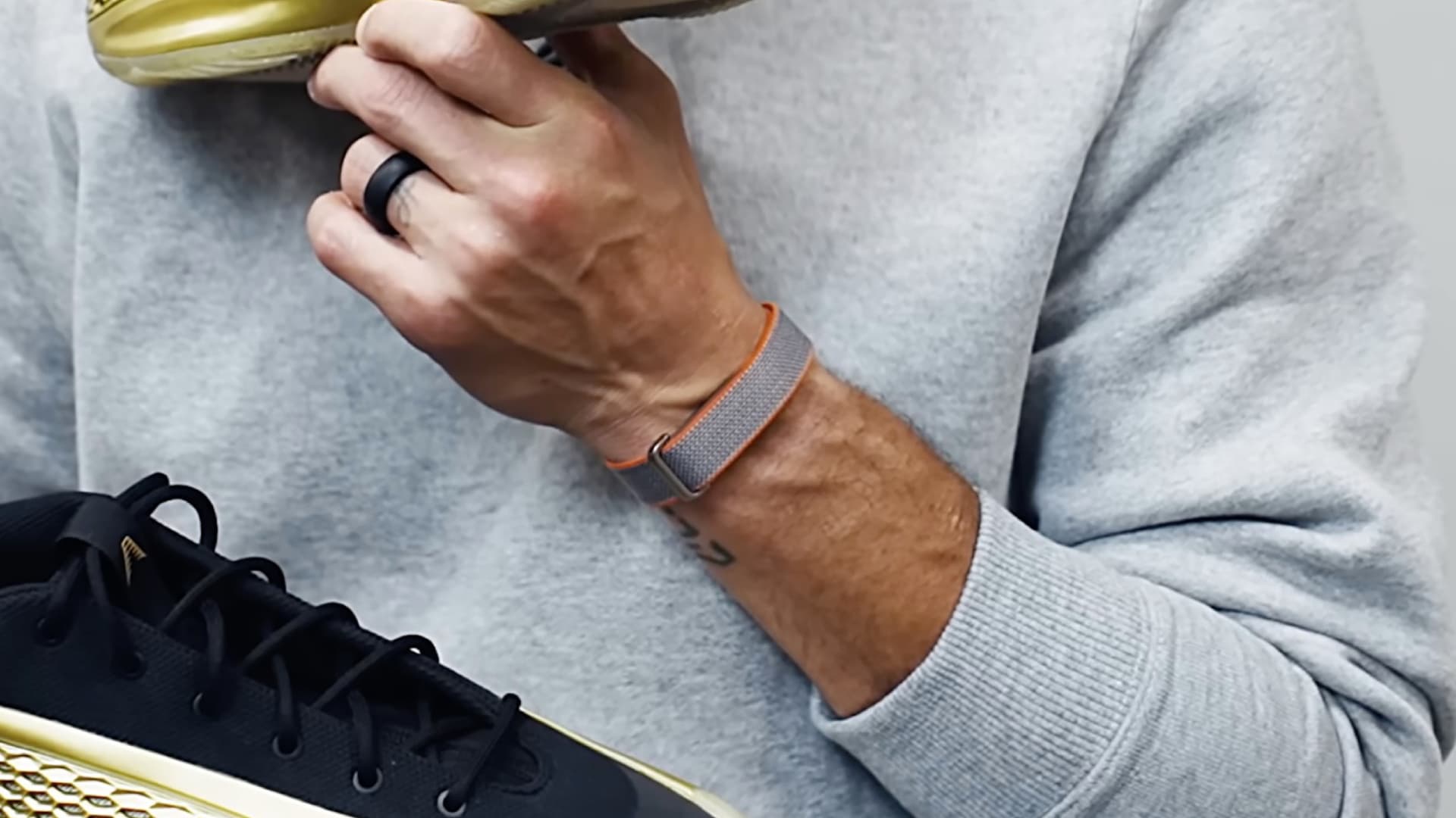 Basketball player Steph Curry wearing an unreleased screenless Fitbit wearable.