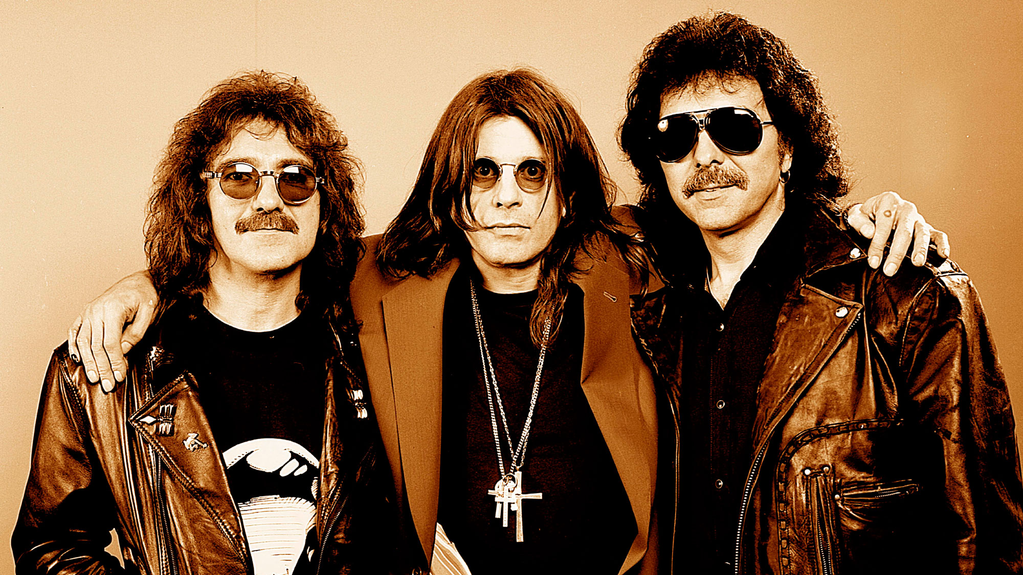 L-R: Geezer Butler, Ozzy Osbourne, Tony Iommi - posed, studio, group shot, at reunion photo shoot