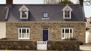 stone house with slate roof and dormer loft conversion