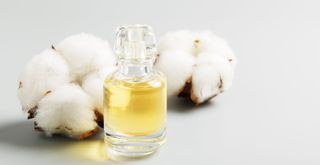 Cotton wool buds with a bottle of essential oil to suggest how to make your house smell good