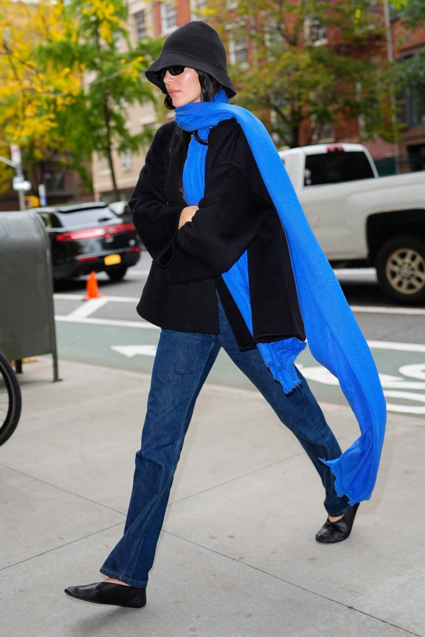 Kendall Jenner wearing a blue scarf, bucket hat, black jacket, dark denim jeans, and black The Row ballet flats