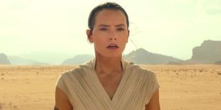 Daisy Ridley looks into distance as Rey in desert background Star Wars: The Rise of Skywalker