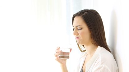 woman drinking water unhappy