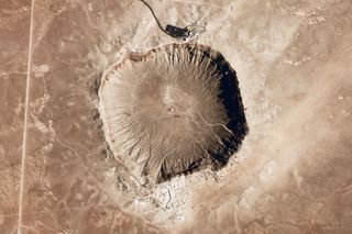 Meteor Crater, an impact crater created about 50,000 years ago when a 30-meter iron meteor struck the Earth's surface in Arizona. The giant Jupiter can redirect asteroid paths towards or away from Earth.