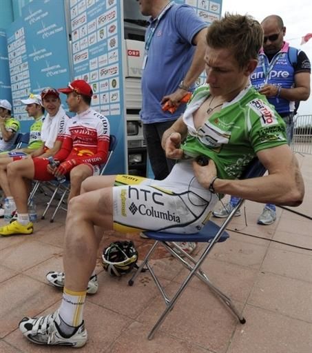 Andre Greipel checks out the damage from the high-speed crash.