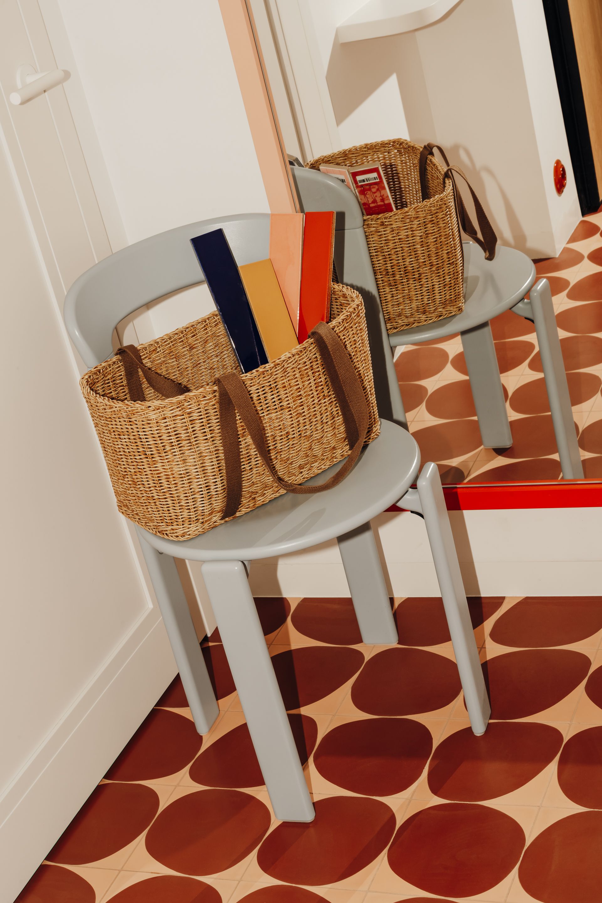 A grey dining chair on an animalistic tiled floor