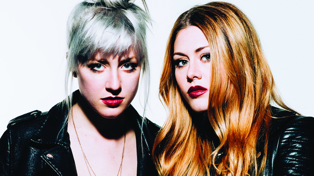 Rebecca and Megan Lovell of Larkin Poe wearing leather jackets and looking at the camera.