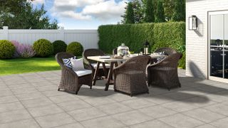 patio with wicker furniture and white fencing