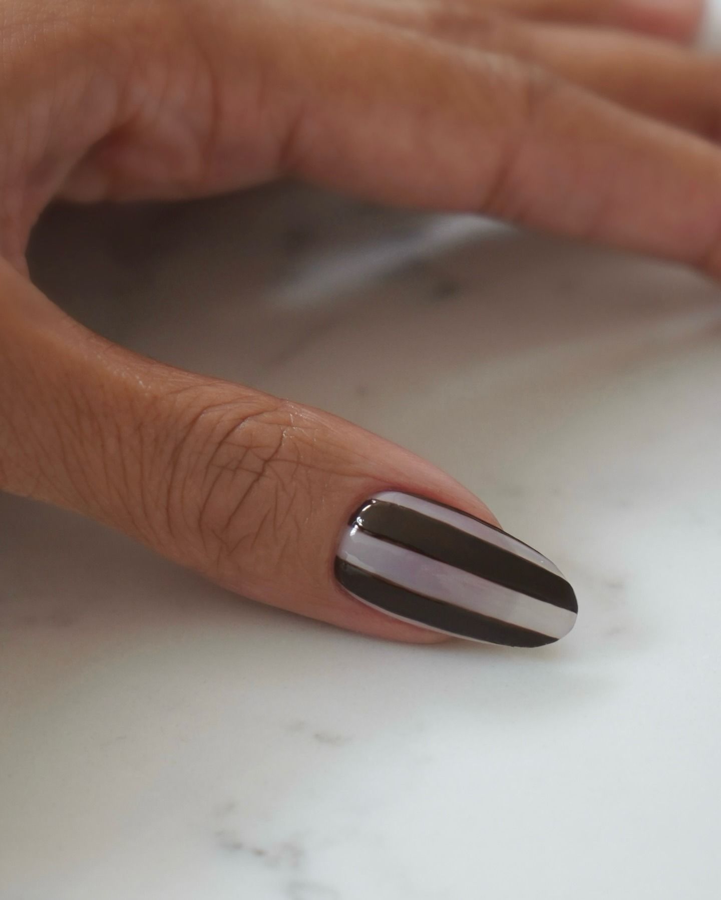 Black and white vertical stripes nail art on long nails