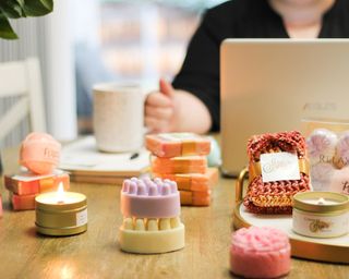 Sustainable soaps in table with laptop in background