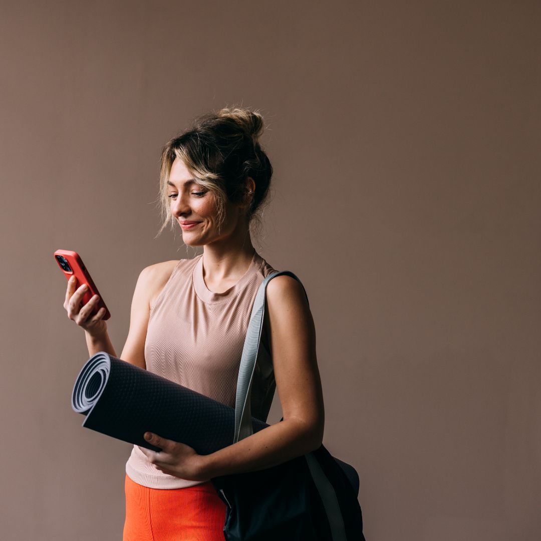 A woman using one of the best Pilates apps