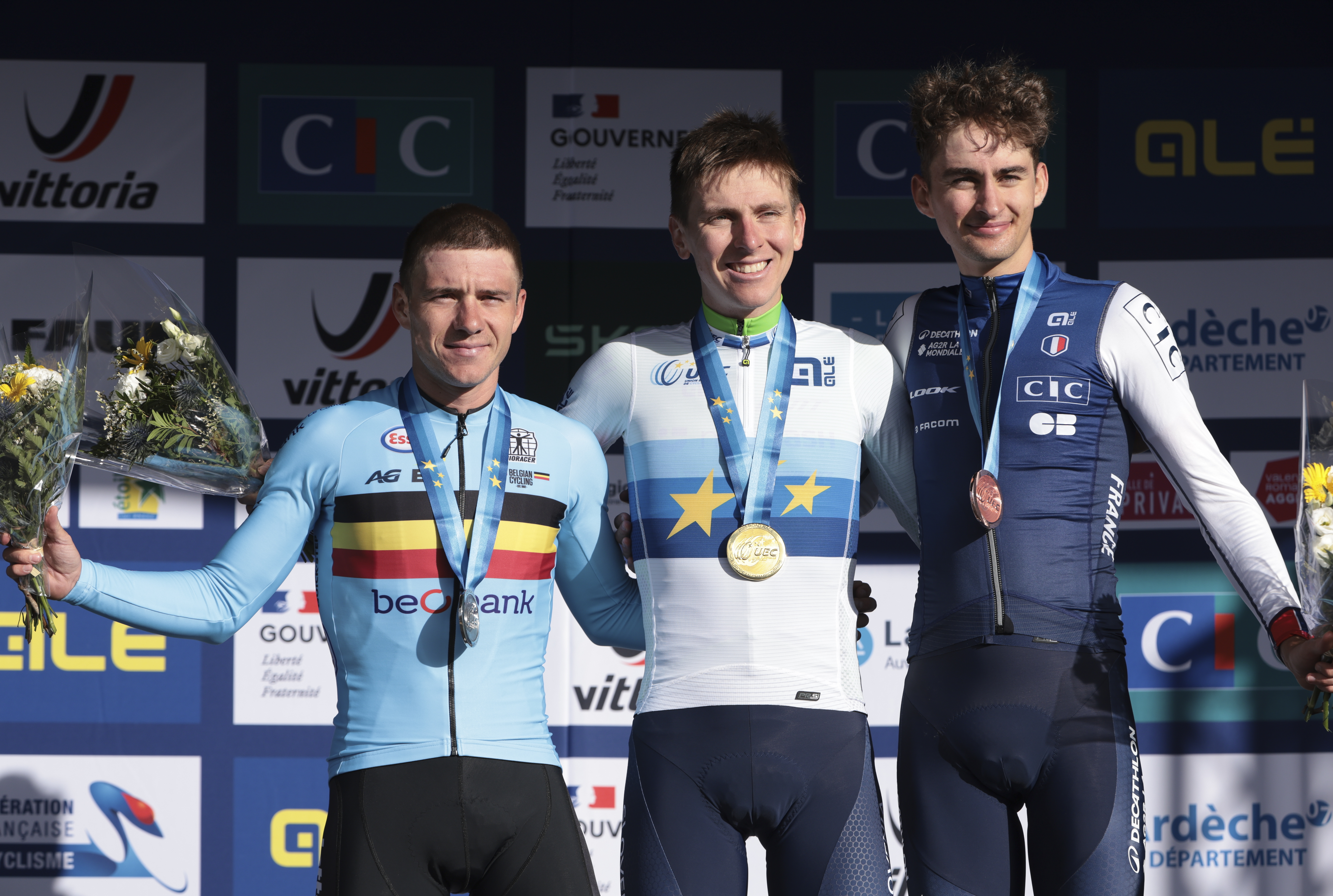 GUILHERAND-GRANGES, FRANCE - OCTOBER 5: Second place and silver medalist Remco Evenepoel of Belgium, winner and gold medalist Tadej Pogacar of Slovenia, third place and bronze medalist Paul Seixas of France during the podium ceremony following the Men&#039;s Elite Road Race of the 31st UEC Road Cycling European Championships 2025, a race of 202.5km between Privas and Guilherand-Granges on October 5, 2025 in Guilherand-Granges, France. (Photo by Jean Catuffe/Getty Images)