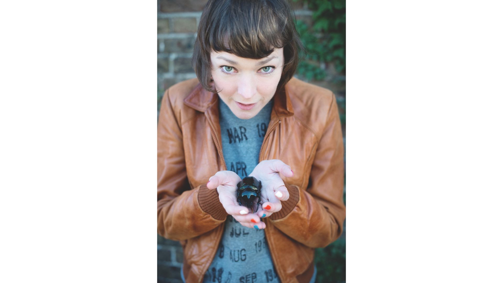 Maya Leonard, who overcame her phobia of spiders and bugs, holds a beetle