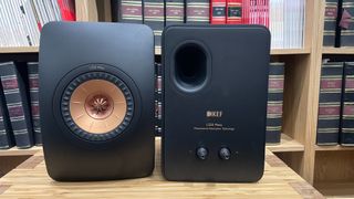 KEF LS50 Meta stereo speakers, one facing front, the other showing rear speaker terminals