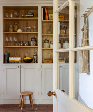 A walk in pantry with built in cabinetry