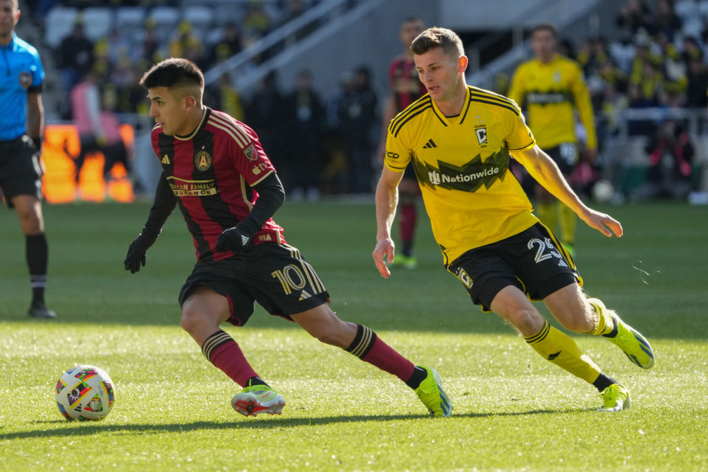 Thiago Almada #10 of the Atlanta United FC dribbles the ball way from Sean Zawadzki #25 of the Columbus Crew during the second half at Lower.com Field on February 24, 2024 in Columbus, Ohio