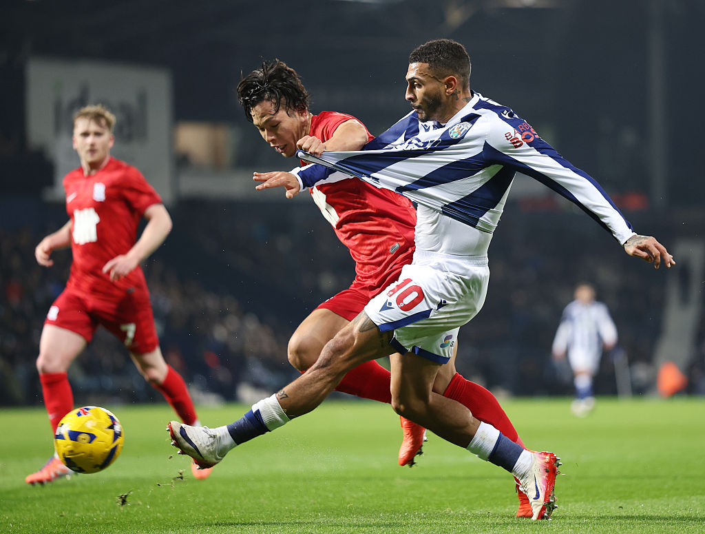 WEST BROMWICH, ENGLAND - NOVEMBER 26: Karlan Grant of West Bromwich Albion crosses the ball under pressure from Tomoki Iwata of Birmingham City during the Sky Bet Championship match between West Bromwich Albion and Birmingham City at The Hawthorns on November 26, 2025 in West Bromwich, England. (Photo by Jack Thomas/Getty Images)