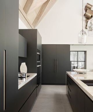 Black cabinets, white kitchen surface