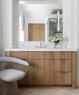 bathroom with reeded bathroom vanity and a small wooden chair