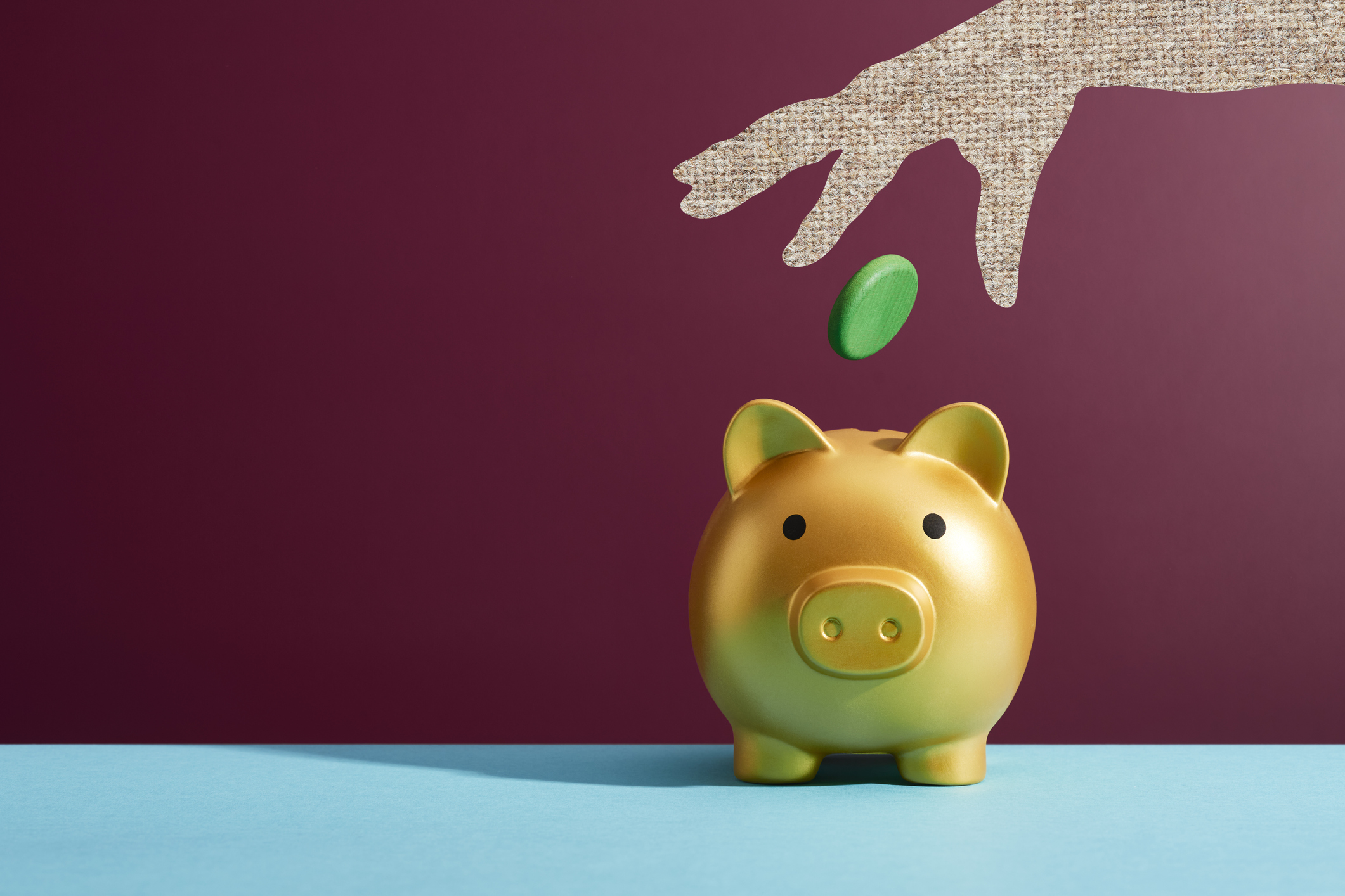 Pension piggybank with someone putting money in