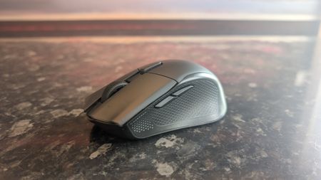The Corsair Harpoon V2 Wireless gaming mouse pictured on a dark marble worktop.