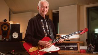 Phil Manzanara photographed at his studio with his iconic Cardinal Red Gibson Firebird, the "flashy" guitar that has stood the test of time in Roxy Music and in his solo career.