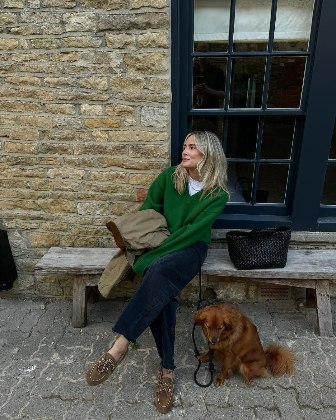 Influencer Lucy wears a green sweater with jeans and suede boat shoes.
