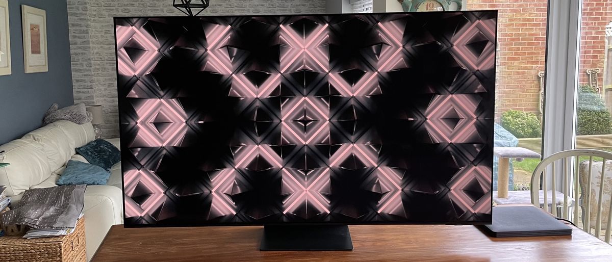 Samsung S95C OLED showing colorful abstract image on table